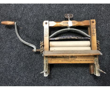 A vintage mangle bearing Anchor Brand Clothes Ringers advertisement 