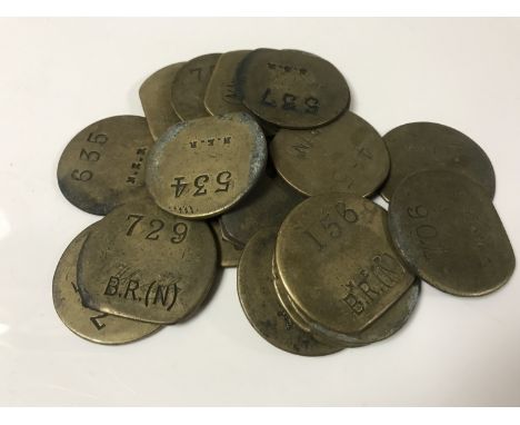 Nineteen vintage brass railway pay check tokens. (19)