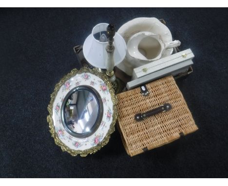 A box of pottery wash jug and basin, table lamps, brass and floral china mirror, picnic basket etc 