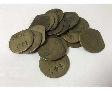 Nineteen vintage brass railway pay check tokens. (19)