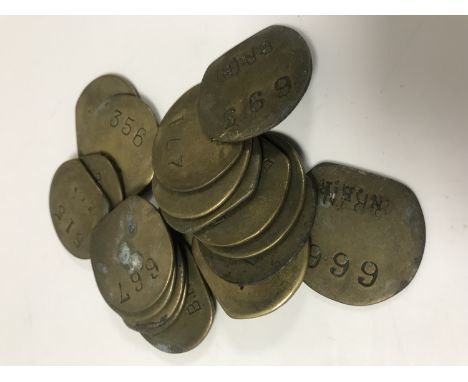 Nineteen vintage brass railway pay check tokens. (19)