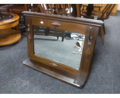 An Edwardian wall mirror with shelf and two coat hooks 