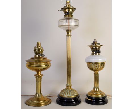 Three late Victorian/early 20th brass oil lamps adapted as electric lamps, one by Taylor & Parsons Ltd, Bradford, 67cmH, one 