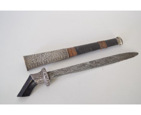 An unusual dagger with hardwood and metal hilt complete with a metal and wooden scabbard with foliate design