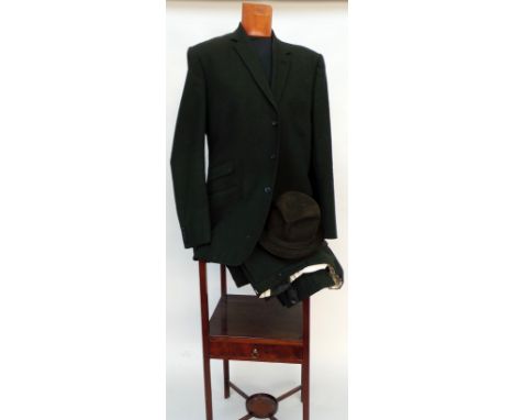 A 1960s worsted wool tailored suit in a deep olive green and with green lining. Labelled H. J. Becker Ltd., EC4 and dated 196