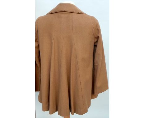 A vintage 1940s style Fox Brothers swing jacket in fine worsted wool. Jacket features two front pockets, three large wooden b