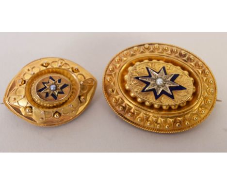 An oval Victorian yellow metal brooch with a central seed pearl, with hair panel, and another similar
