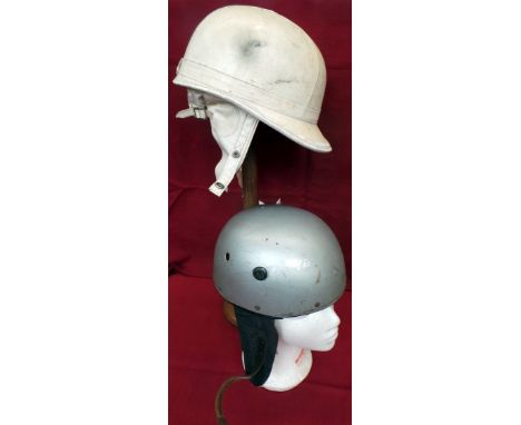 Two vintage motorcycle helmets. A circa 1960s cream  'Aviakit' helmet, well used but good condition throughout. Another earli