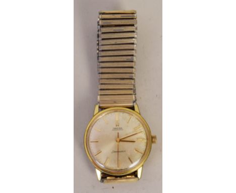 An Omega Seamaster gentleman's wrist watch dating from the 1960s/70s, with cream dial and gold coloured hands in a yellow met