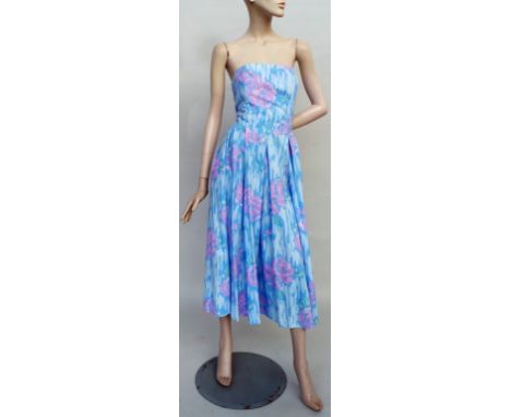 A 1980s strapless cotton sun dress and matching bolero jacket in pale pinks and blues. Garment features boned bodice, side po