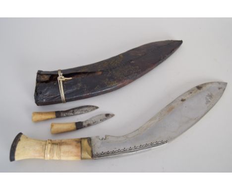A kukri/khukuri dagger, with carved bone handle complete with smaller karda blade and chakmak sharpener also with carved bone
