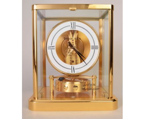 A Jaeger-LeCoultre Atmos clock, with white circular dial, in gilt metal case with clear glass panels for Tiffany & Co, 22cmH
