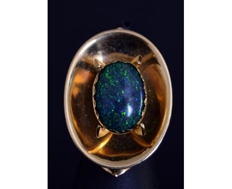 Australian Interest: An Australian 18ct gold and black opal solitaire ring by Rod Edwards, the oval cabochon held in an open 