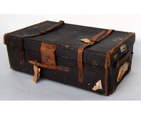 A leather and canvas travel trunk with leather strapping and travel labels and stickers, 80 x 30 x 50cm