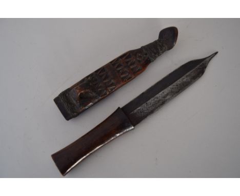 A dagger with carved wooden scabbard and hilt, possibly from the Philippines, 30cmL
