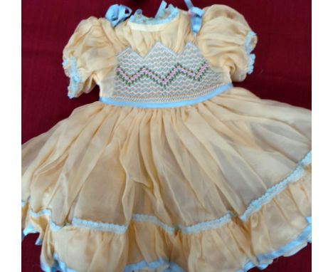 A beautifully hand finished soft cotton babies dress with smocking to front and back, as new condition. Two further dresses m