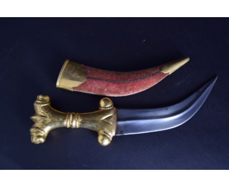 A janbiya dagger with medial ridge and yellow metal hilt featuring two lions in a metal and fabric covered scabbard, 28cmL