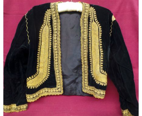 A vintage black velvet lined bolero jacket embellished with gold cololoured thread to edgings and cuffs. Size 10-12 and in fa