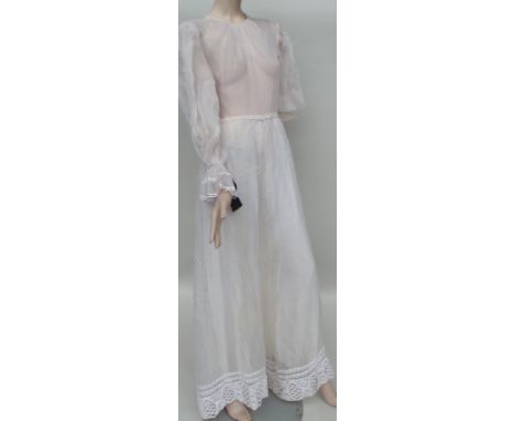 A 1960s/70s 'Gina Fratini' tulle dress. The skirt is lined but the top half is not. Full sleeves are gathered at the wrist an