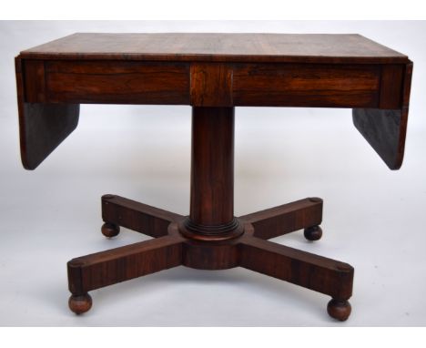 A late Regency/ early Victorian rosewood sofa table of simple angular form with two short drawers