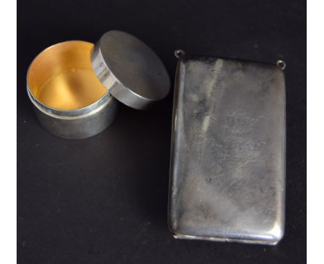 An Art Deco sterling silver cigarette case with two eyelets at the top, possibly for attaching a chain, and engraved with 'SP