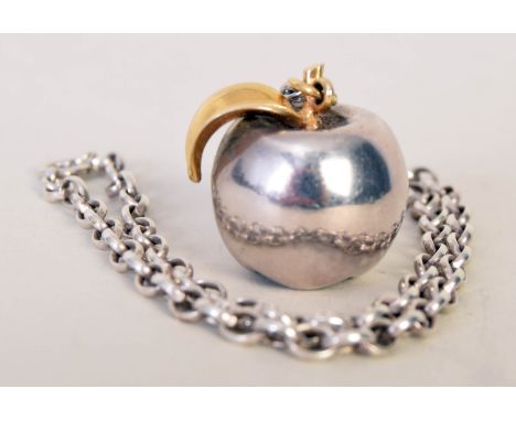 A mid-20th century silver apple pendant with a gilt metal leaf on a simple chain, EJ Ld, London 1975, 1.23oz