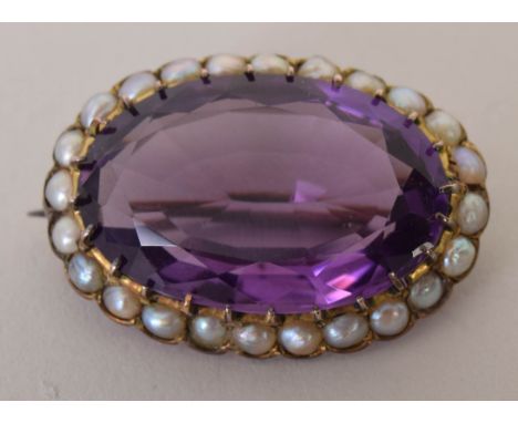 A 19th century amethyst and seed pearl oval brooch