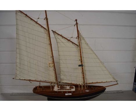 Modern model boat on wooden plinth base