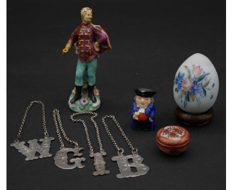 A collection of items. Including a Victorian blown glass easter egg, four silver plate engraved decanter labels, a hand paint