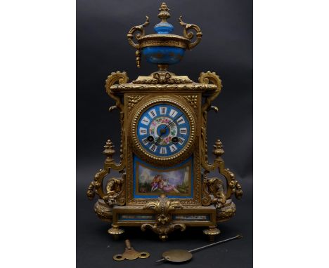 An early 20th century French gilt metal and porcelain mantel clock with eight day movement and hand painted decoration, with 
