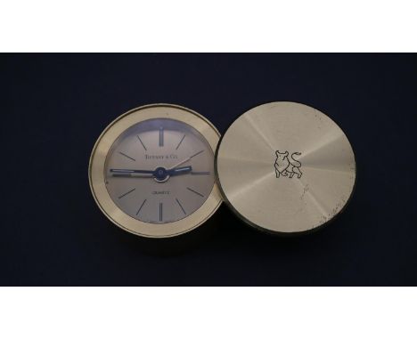 A Tiffany &amp; Co. miniature portable alarm clock with Merrill Lynch logo to the sliding case cover, Swiss made with quartz 
