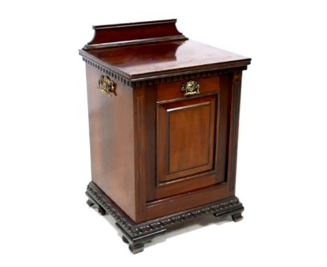 An Edwardian mahogany purdonium, with carved lower rim, two brass handles to the sides, fall front, a/f missing metal hopper,