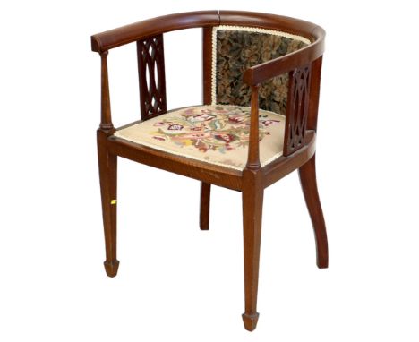 An Edwardian mahogany open armchair, with tapestry seat. 