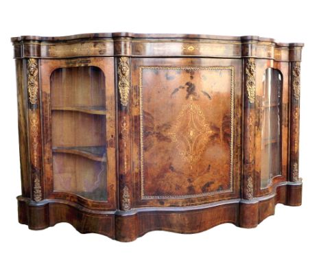 A Victorian walnut veneered serpentine fronted credenza, marquetry inlaid and gilt metal mounted, central panel door flanked 