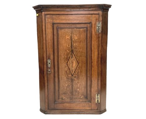 A 19th century oak corner cupboard, with shell inlay to its single door, three interior shelves, 72 by 41 by 101.5cm high.