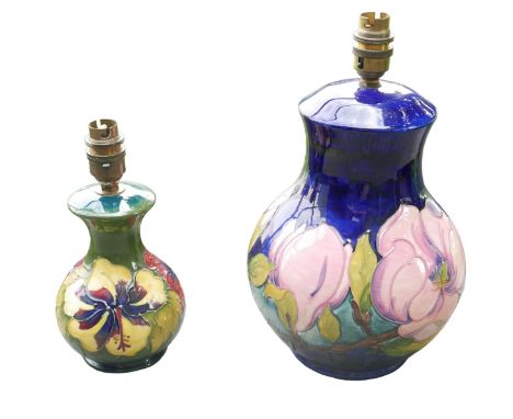 Two Moorcroft table lamps, comprising a large magnolia pattern lamp, 17.5 by 31cm overall, together with a smaller hibiscus p