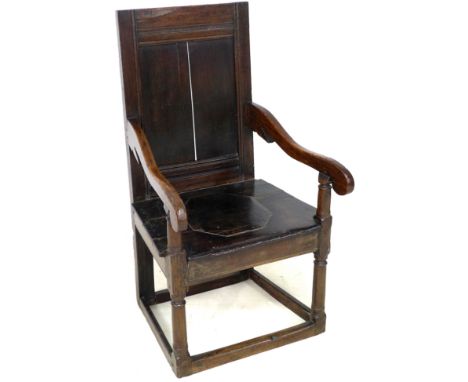 A 17th century oak Wainscot chair, with open scroll end arms, solid seat with octagonal section inset, plain single panel bac