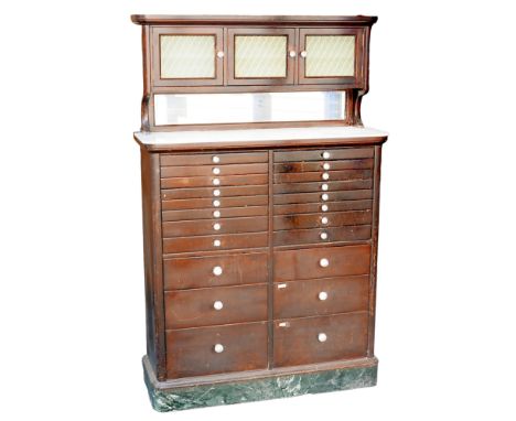 An Edwardian mahogany dentist's cabinet, with an upper section of three glazed doors enclosing storage trays, over an open sh