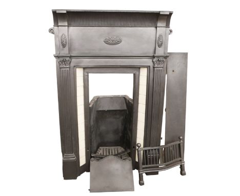 An Edwardian style cast iron fire surround with grate, decorated with cream tiles. 