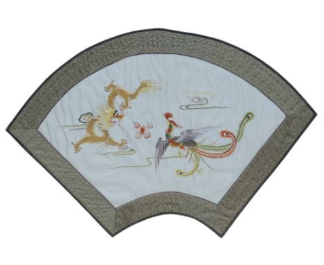 A 20th century Chinese textile panel, of fan shape form, with embroidered with a Dragon and Phoenix, 70 by 49cm overall, glaz