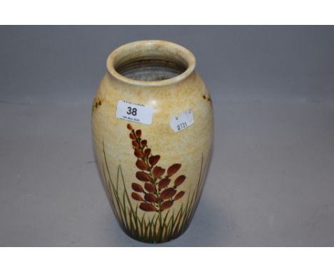 An art deco pottery vase hand decorated with floral scenes by Radford