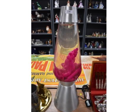 A large size polished steel and pink wax lava lamp