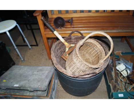 A plastic container; two wicker baskets and a vintage tennis racket