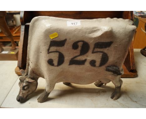 A Studio pottery model of a cow (number 525)