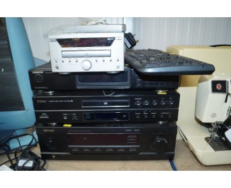 A Teac CD player with remote control; a computer keyboard; a Kenwood AM/FO/FM stereo tuner; a Sherwood integrated amplifier a