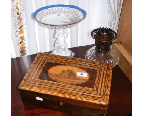 An inlaid workbox, together with ceramic table centre and oil lamp