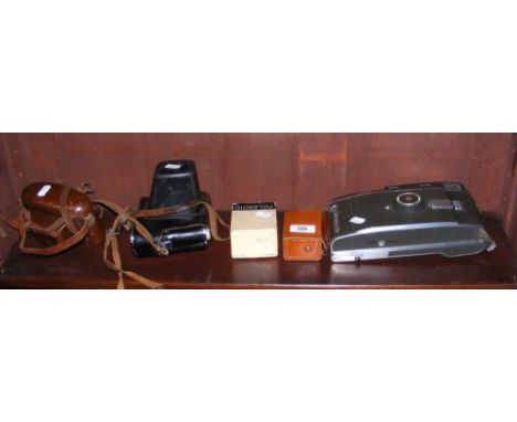 A very large vintage camera, together with others