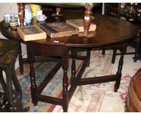 A country antique oak gate-leg table with single drawer