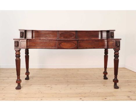 A Regency mahogany sideboard in the manner of Thomas Hope,c.1820, with lion mask, applied mouldings, raised incurved back wit