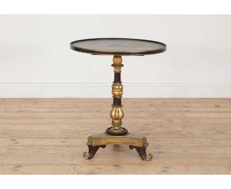 A circular low occasional table,19th century, the top painted with fruit on a stone ledge, over a grained and gilt, turned an